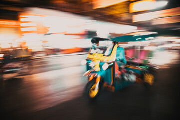 blurred tuk tuk in traffic in Bangkok