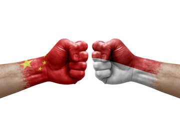 Two hands punch to each others on white background. Country flags painted fists, conflict crisis concept between china and monaco