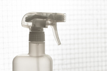 Fototapeta na wymiar Close up white plastic foggy spray bottle head. Background for plastic in daily use.