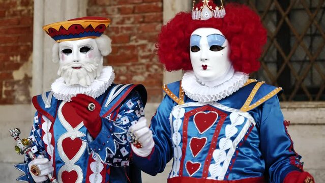 Venice, Italy - February 2022 - carnival masks are photographed with tourists in San Marco square