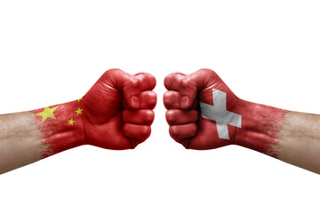 Two hands punch to each others on white background. Country flags painted fists, conflict crisis concept between china and switzerland