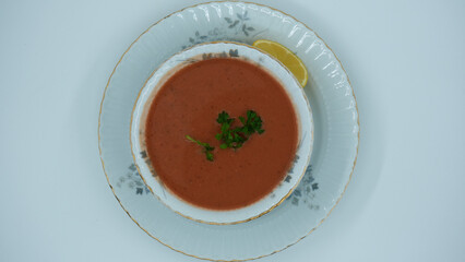 Red vegetable soup with lemon and parsley