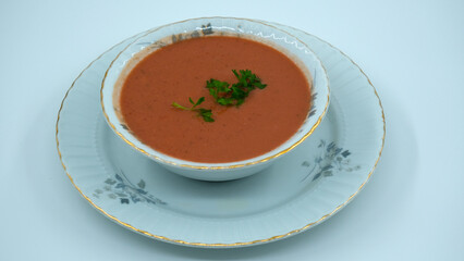Vegetable soup with lentils in a flowery white bowl, red soup