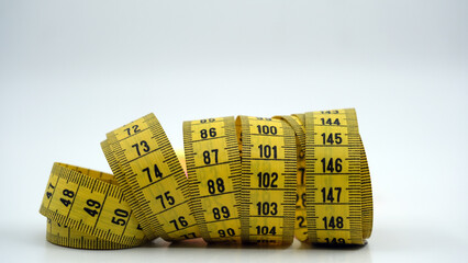 yellow tape measure on a white background