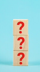 QUESTION The shape of a wooden cube block with a question mark symbol on a blue background. The...