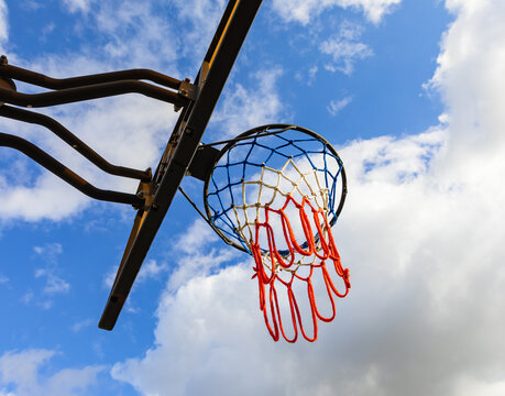Basketball hoop on a blue sky. Basketball hoop in the public arena. Street photo, nobody, copy space for text
