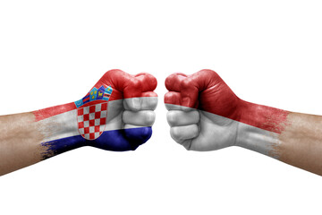 Two hands punch to each others on white background. Country flags painted fists, conflict crisis concept between croatia and monaco