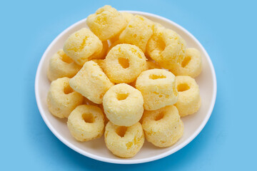 Roller corn snack on blue background.