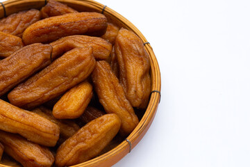Sun-dried bananas in bamboo basket on white background.