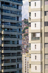 Rocinha favela between the buildings of the Sao Conrado neighborhood in Rio de Janeiro, Brazil.