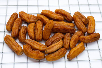 Sun-dried bananas on white background.