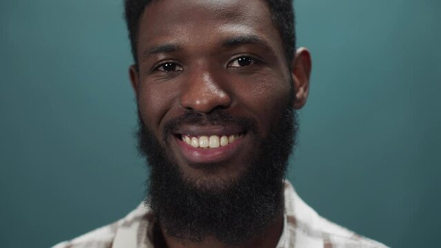An attractive black guy smiles at the camera and swings in different directions