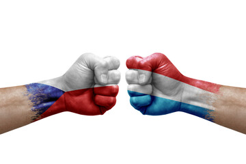 Two hands punch to each others on white background. Country flags painted fists, conflict crisis concept between czechia and luxembourg