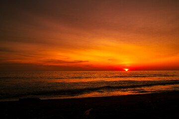 Fototapeta na wymiar Beautiful seascape at sunset with dramatic golden sky
