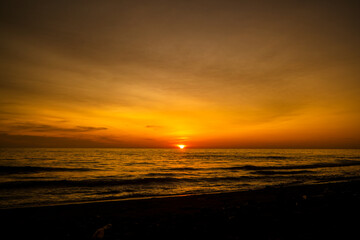 Beautiful seascape at sunset with dramatic golden sky