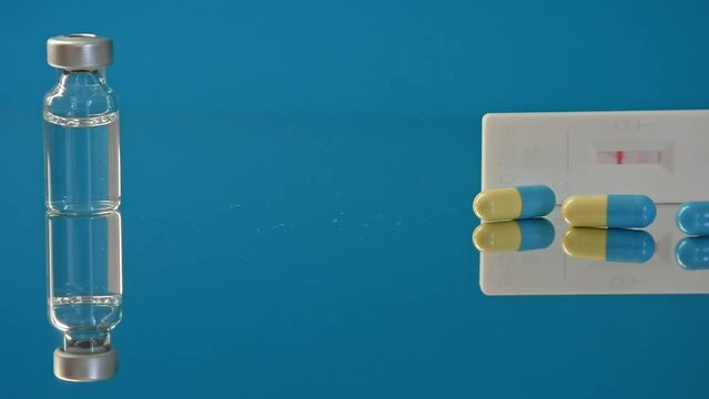 Vaccine bottles and syringe, treatment for COVID-19, influenza or flu, worldwide mass vaccination for coronavirus, global immunization concept with third booster dose. 4K resolution