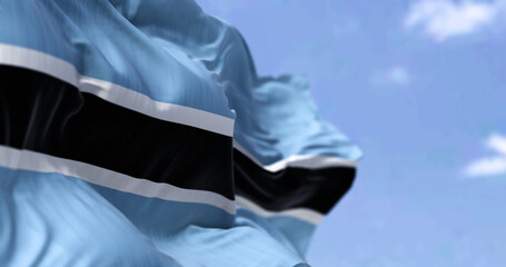 Detail of the national flag of Botswana waving in the wind on a clear day.