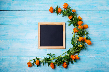 Black square chalkboard frame mockup with globeflowers