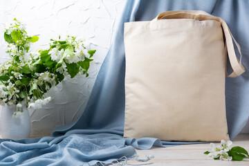 Rustic tote bag mockup with apple blossom in the vase