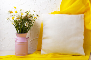 Pillow mockup with daisy flowers and yellow scarf