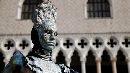Venice, Italy - February 2022 - carnival masks are photographed with tourists in San Marco square