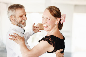 Keeping the romance alive. Shot of a mature couple dancing together in formal attire.