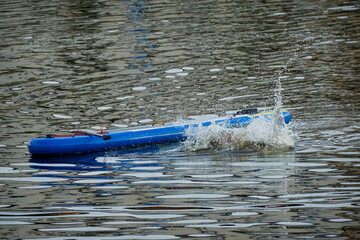 splashes from a man diving into the water from a sup