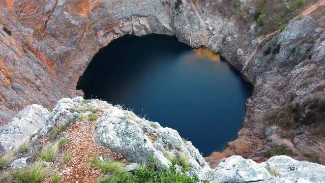 Beautiful scenic landscape view of the Red lake. The biggest limestone crater and sinkhole in Europe. Containing Karst lake with high cliffs and a deep lake in Croatia, Europe. A picturesque location.