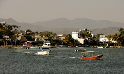 Fototapeta na wymiar Water taxis run between the town of Barra Navidad and the Grand Isla Navidad Resort