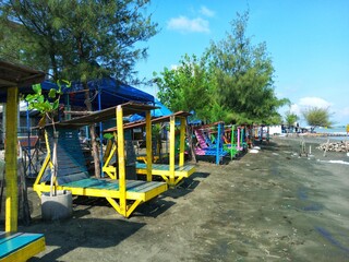 Fototapeta na wymiar lounge chairs for sunbathing on the beach with colorful, beach view, beach trees