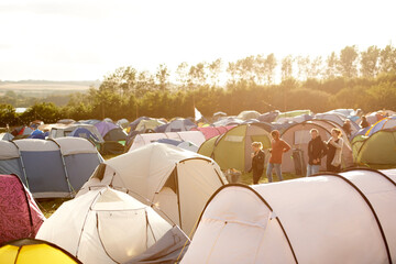 Camping is the way to go. Shot of a large group of tents on a campsite at a festival. - obrazy, fototapety, plakaty