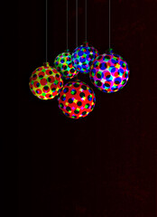 hanging balls with colorful halftone patterns on a dark background