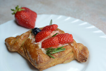 Puff with strawberries on a plate
