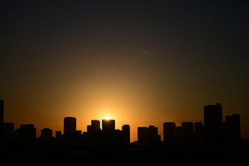 The sun setting over the buildings