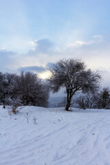 Winter morning sunrise in the mountains panoramic view from the site located on the ridge of the tourist route.