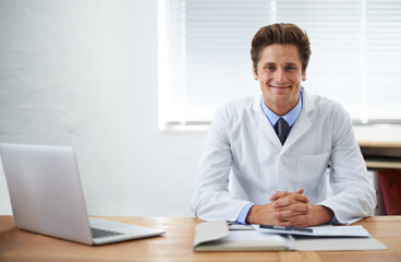 Fototapeta na wymiar Hes confident in his medical abilities. Portrait of a smiling doctor sitting at his desk.