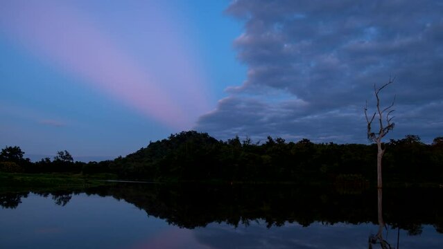 Beautiful dusk scenic sunset with rays of sun shining through dramatic clouds 4K ProRes UHQ Timelapse