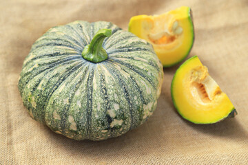 Fresh organic pumpkin on sack in kitchen for cooking in daily life meal. selective focus.
