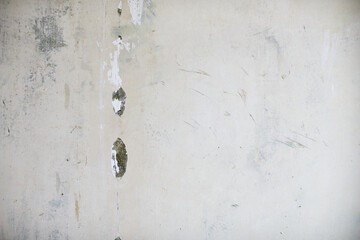 The texture of the wall with swollen and peeling paint. Front view.