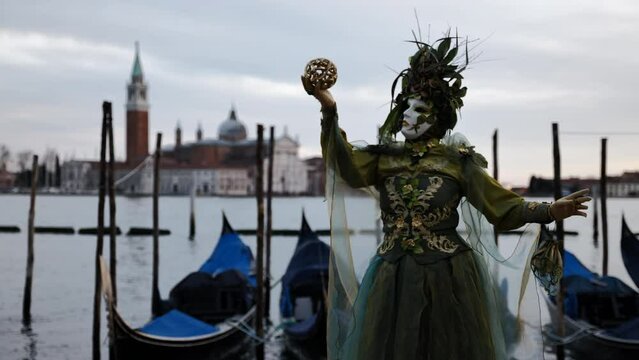 Venice, Italy - February 2022 - carnival masks are photographed with tourists in San Marco square