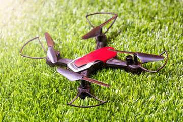 Quadrocopter on the grass, a toy with propellers