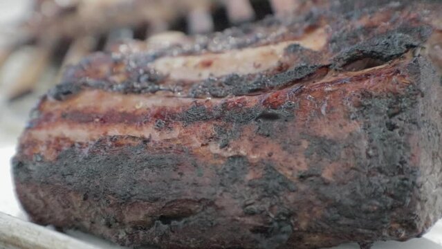Beef Rib cooking on high heat barbecue. Slow Motion