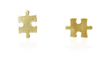 Business is like a puzzle. Shot of a two puzzle pieces against a white background.