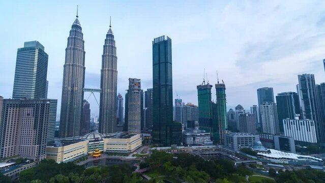 Time-lapse footage of modern unique building Petronas Twin Tower (KLCC) and surrounding during sunrise hours