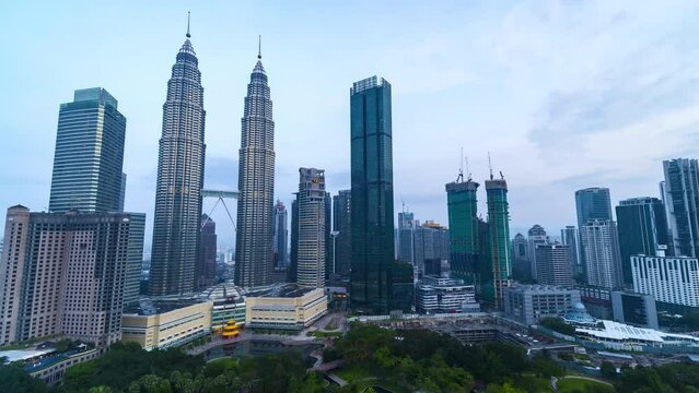 Time-lapse footage of modern unique building Petronas Twin Tower (KLCC) and surrounding during sunrise hours