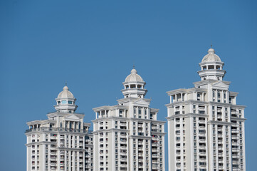 A row of white European style buildings are under the blue sky