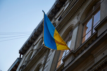Lviv, Ukraine. Ukrainian flag in city building. War in Ukraine