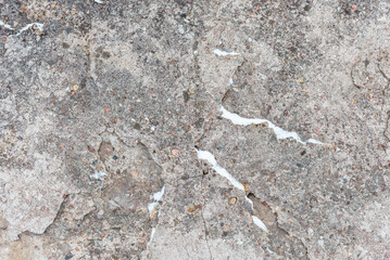 Cracked concrete wall gray cement surface background.cracked grey stone wall in winter.close-up.