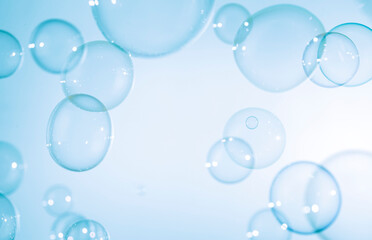 Transparent Blue Soap Bubbles Floating on White Background.