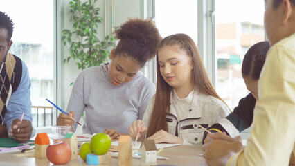 A group of multi ethnic of students kids and teachers study, learn art painting, drawing in school. Education in classroom. People lifestyle